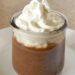 Quick and elegant chocolate Pots de Creme topped with whipped cream in a glass jar
