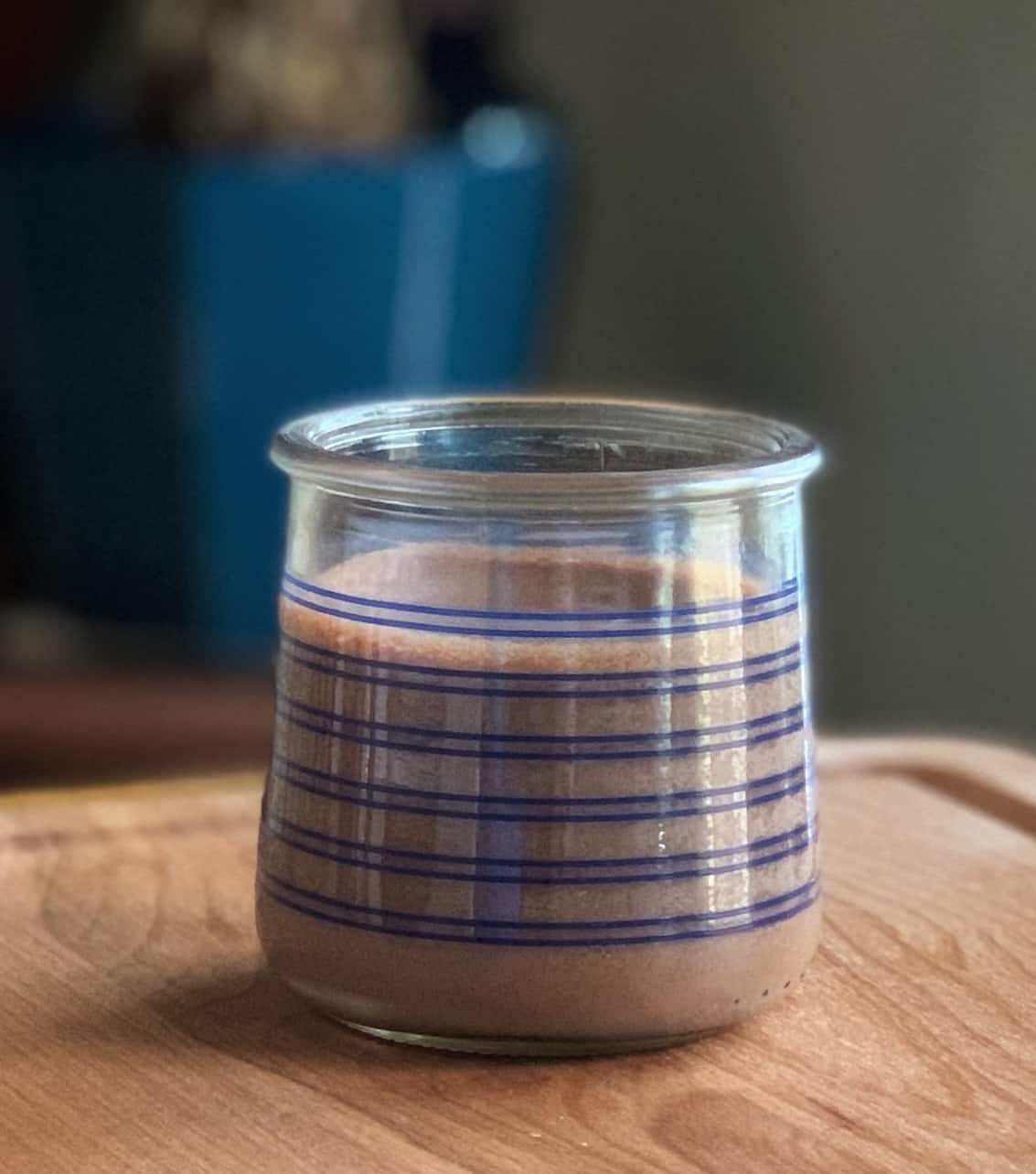 Pots de Creme topped with whipped cream in a blue-striped glass jar