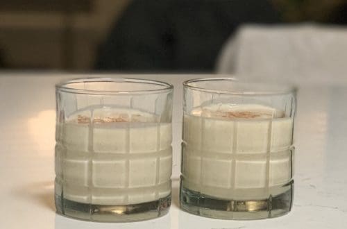 Two glasses of Authentic Puerto Rican Coquito garnished with cinnamon
