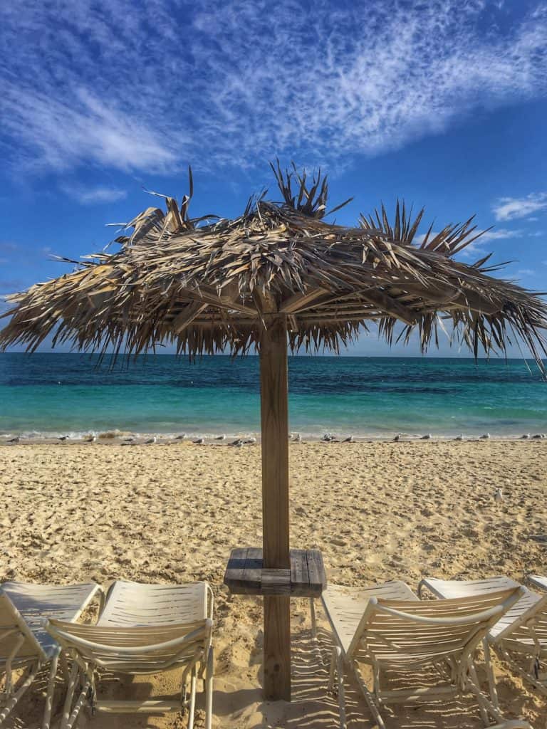 Beach chairs facing the water in Freeport, Bahamas