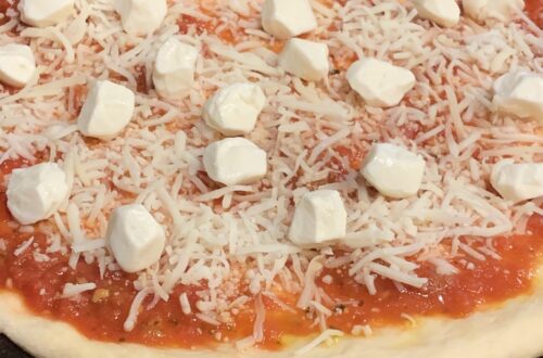 Bread Machine Pizza Dough topped with tomato sauce and fresh mozzarella