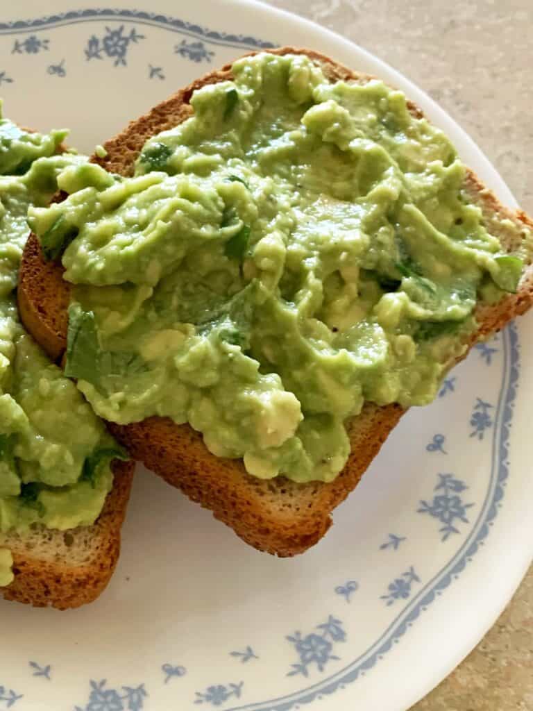Slices of avocado toast with sea salt, cilantro and lime juice