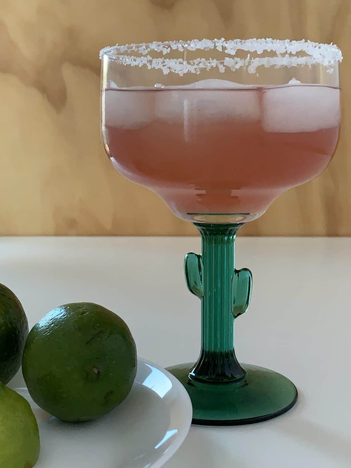 Pink margarita on the rocks cocktail recipe in a cactus-themed margarita glass