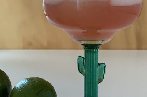 Pink margarita on the rocks cocktail recipe in a cactus-themed margarita glass