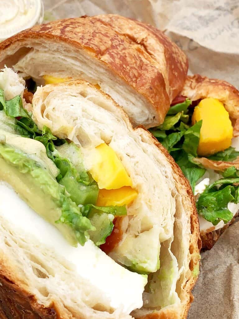 Tropical signature sandwich with avocado, fresh mozzarella, and mangoes from La Sandwicherie, one of the best sandwiches in South Beach