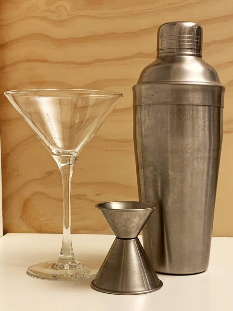 Martini glass, cocktail shaker, and jigger