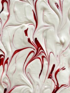 Closeup of white chocolate swirled with red food coloring