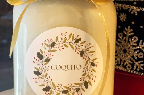 Homemade Coquito gift with a gold ribbon
