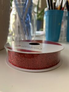 Spool of sparkly red riboon