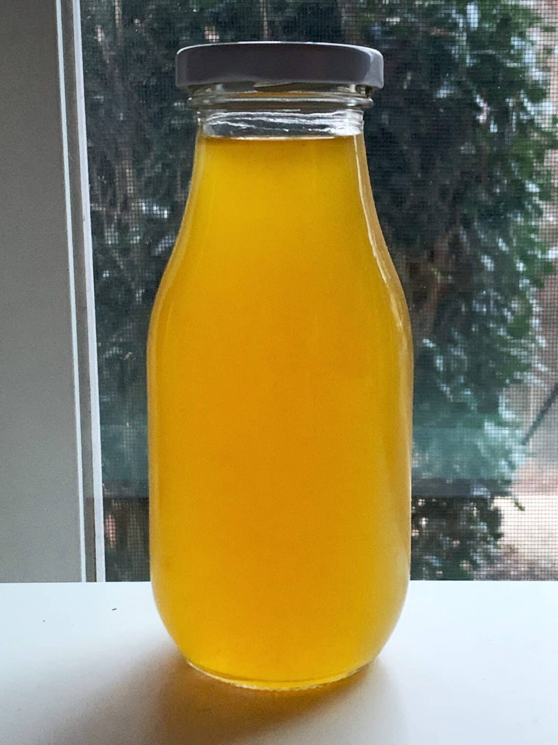 Homemade mandarin orange simple syrup recipe made in a glass bottle