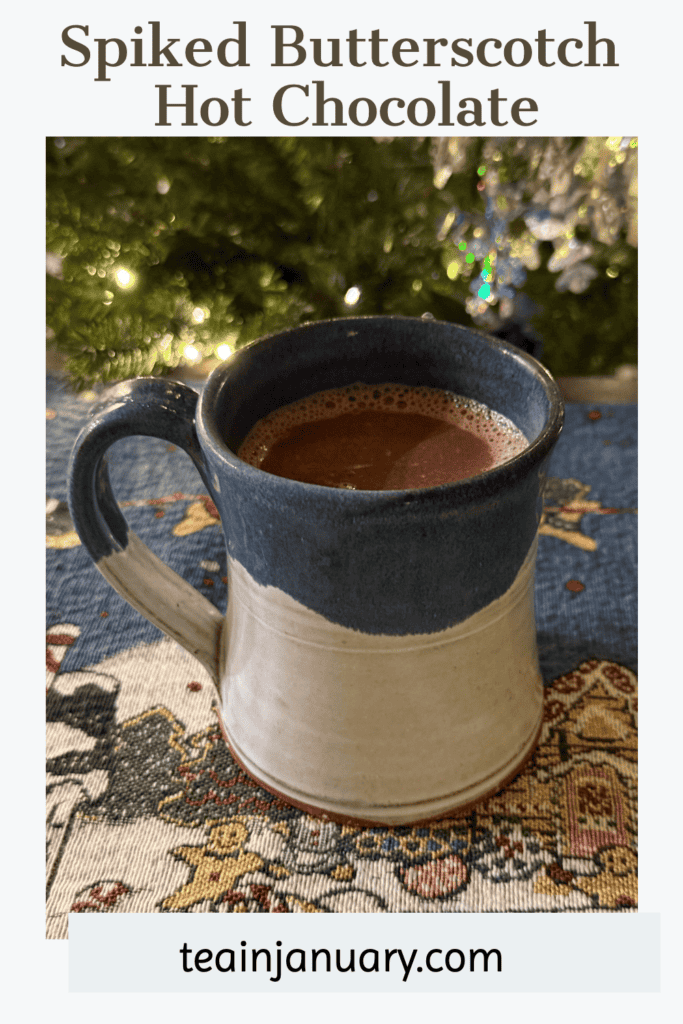 Pinterest pin of spiked butterscotch hot chocolate in a mug in front of a Christmas tree