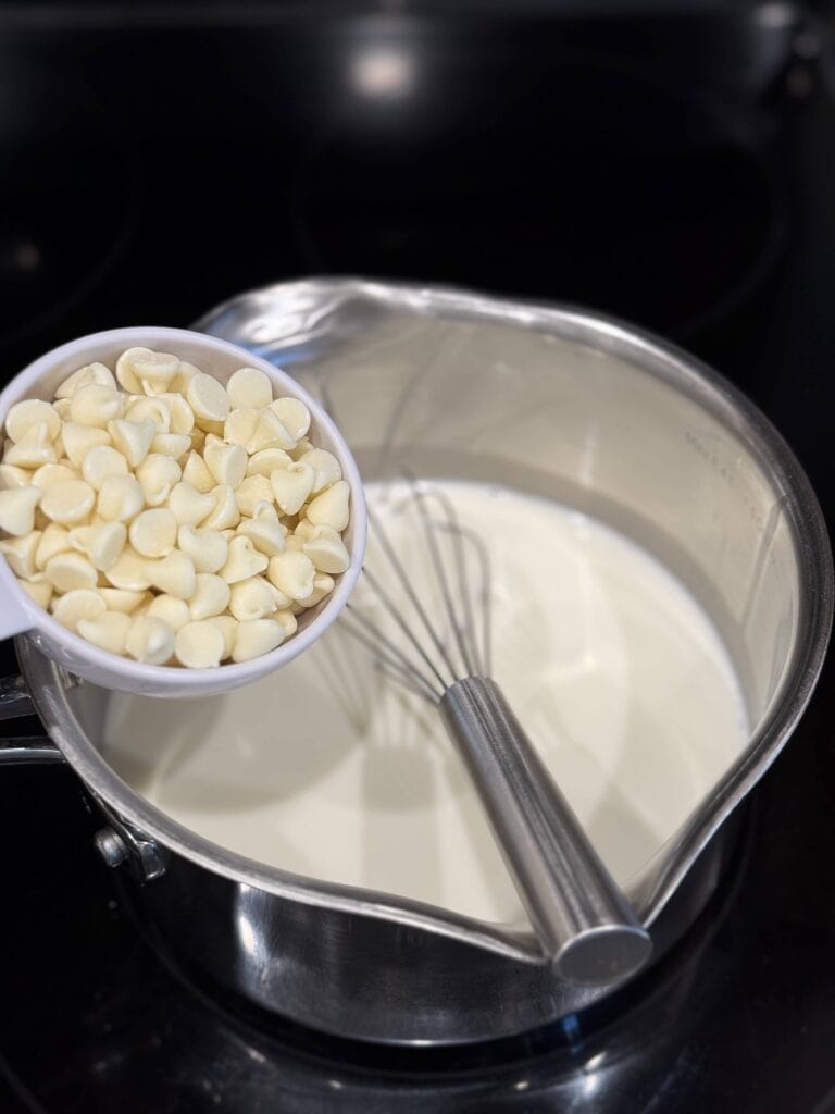 Preparing White Chocolate Peppermint Creamer recipe on the stovetop with white chocolate chips