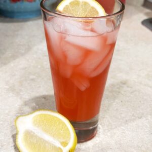 Pink Raspberry Vanilla Lemonade in a tall glass with ice