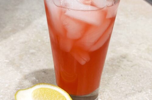 Pink Raspberry Vanilla Lemonade in a tall glass with ice